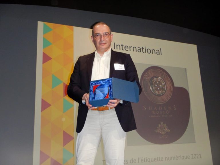 Photo of Nicolas Venance, MGI Digital Technology marketing manager, receiving a trophy for Rotocel and MGI